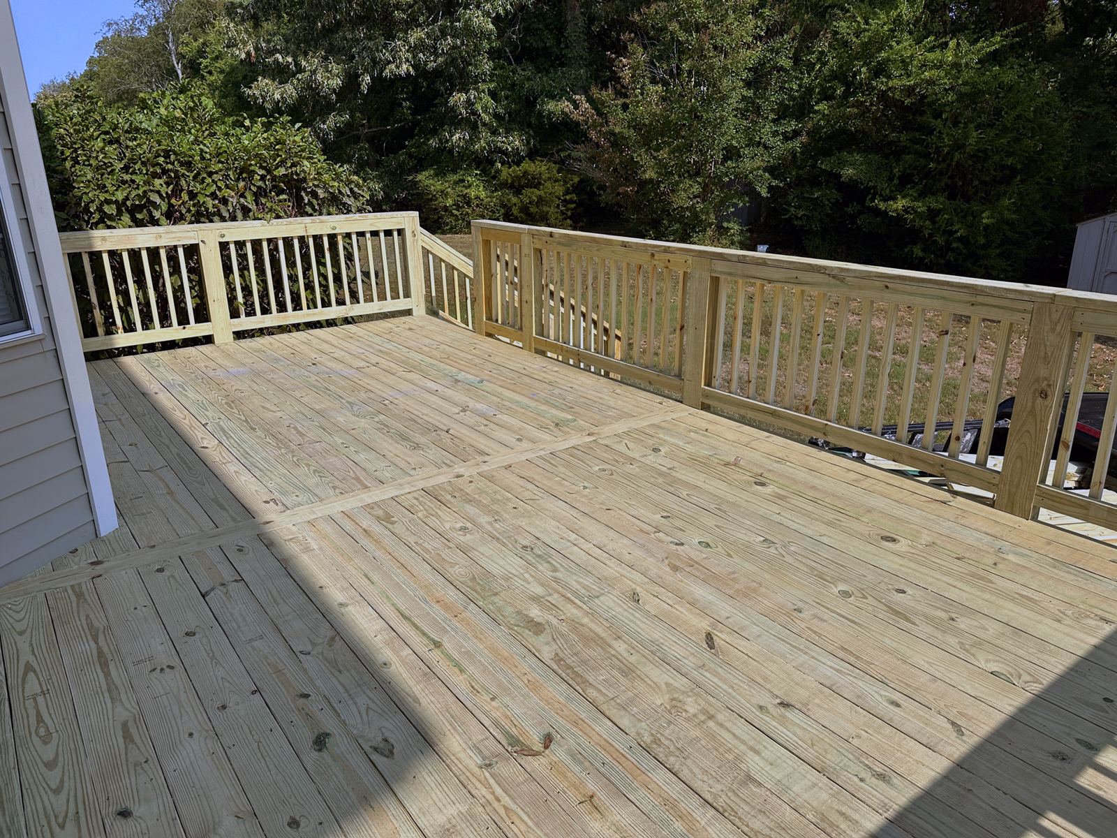 Raised pressure-treated deck with full railing